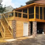 A dry storage room beneath an outdoor deck with screen porch and deck waterproofing system.