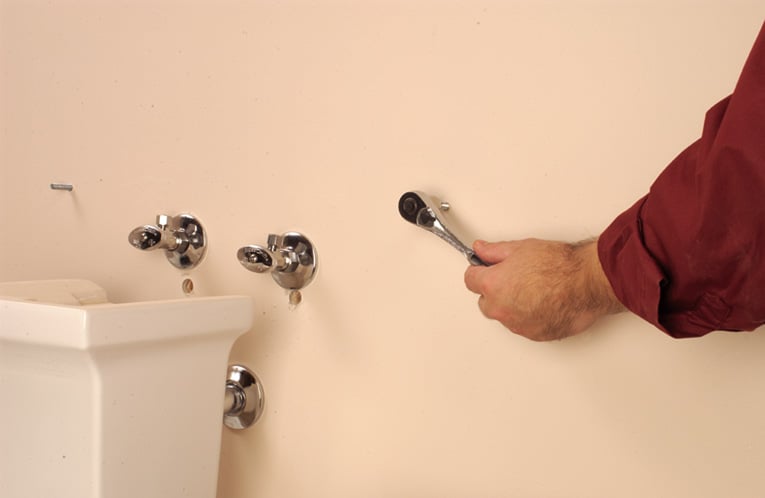 Attach wall and floor fasteners.
